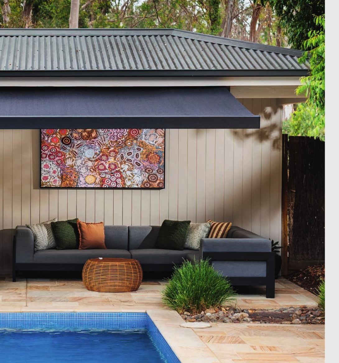 Dark Siena awning shading an outdoor lounge by the pool